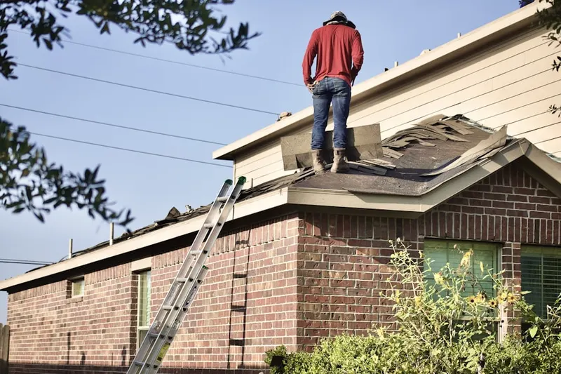 Professional roofer working on a residential roof in Aiken
